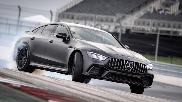 Ein grauer Mercedes-AMG GT 63 S auf einer Rennstrecke driftet und erzeugt Rauch.