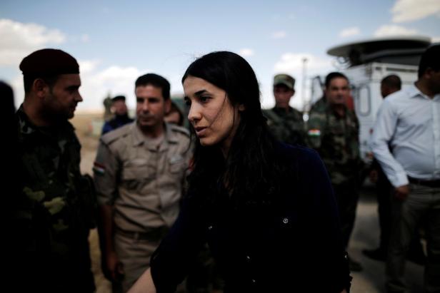 FILE PHOTO: Yazidi survivor and United Nations Goodwill Ambassador for the Dignity of Survivors of Human trafficking Nadia Murad greets Kurdish Peshmerga fighters at a defensive point near Sinjar