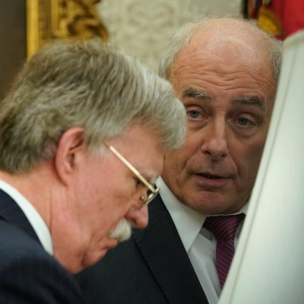 White House Chief of Staff Kelly speaks to National Security Advisor Bolton in the Oval Office at the White House in Washington