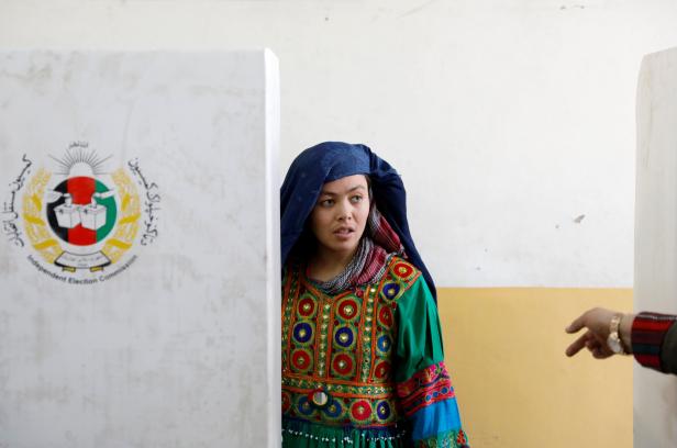 An Afghan woman casts her vote during parliamentary elections at a polling station in Kabul