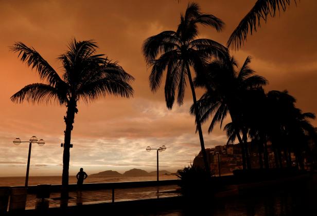 A man looks at the sea along the Mazatlan boardwalk as Hurricane Willa approaches the Pacific beach resort