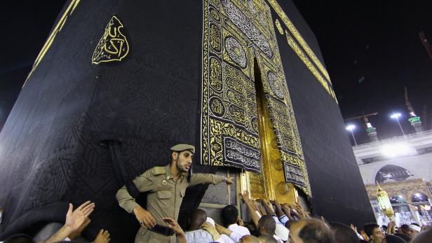 Member of Saudi security forces gestures as Muslim
