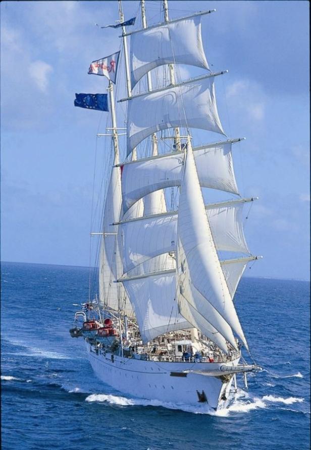 Ein weißes Segelschiff fährt auf dem offenen Meer.