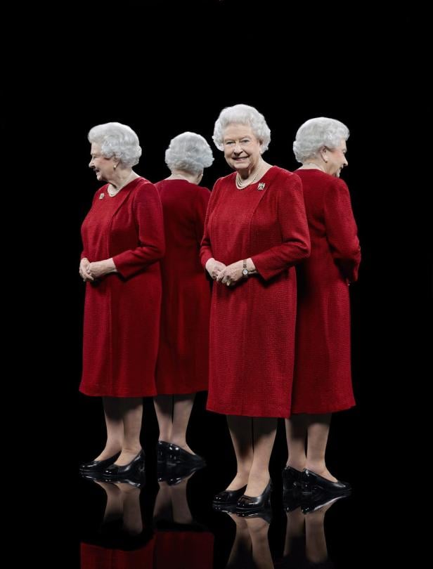 Königin Elisabeth II. in einem roten Kleid, umgeben von Spiegelbildern.