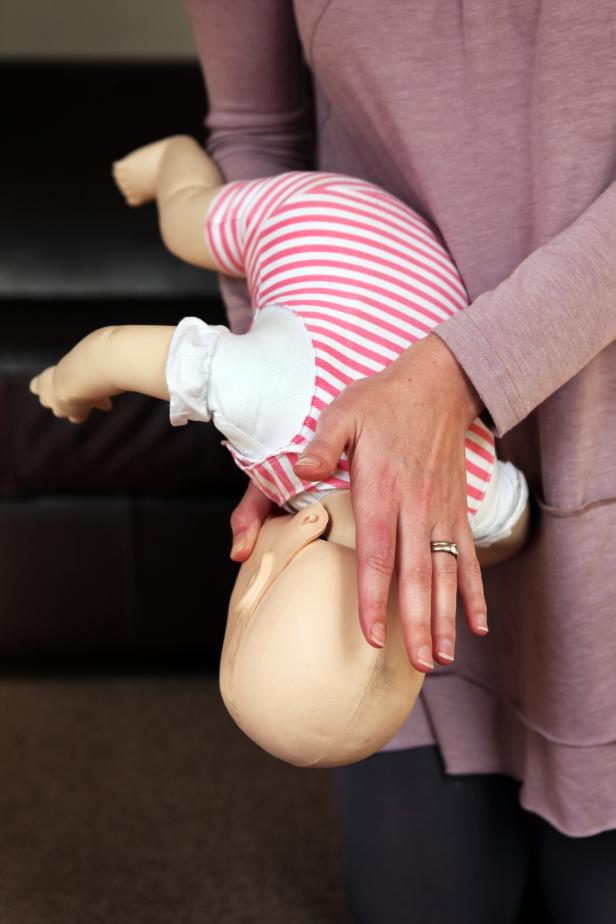 A woman trains to help a baby that is choking