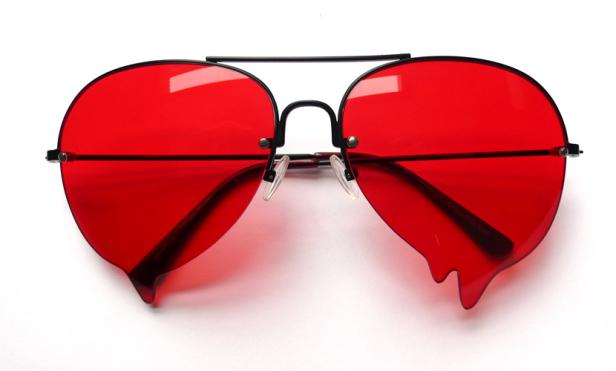 Eine Pilotenbrille mit roten Gläsern, die wie Tropfen geformt sind.