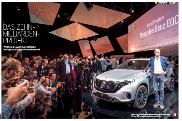 Ein Mann posiert neben dem neuen Mercedes-Benz EQC vor Publikum.