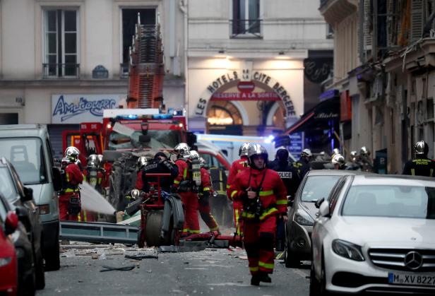 Firemen and police officers work at the site of an explosion in a bakery shop in the 9th District in Paris