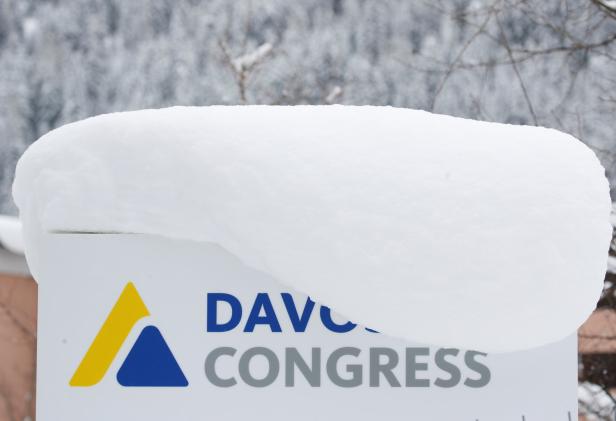 A snow-covered sign is seen in front of the congress centre, the venue of the World Economic Forum in Davos