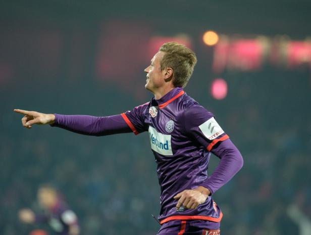 Ein Fußballspieler des FK Austria Wien zeigt während eines Bundesligaspiels nach links.