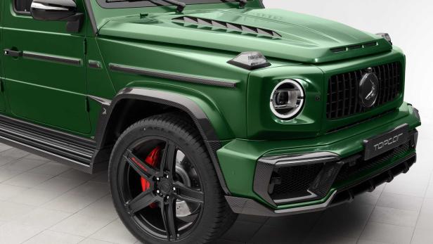 Detailansicht eines grünen Mercedes-Benz G-Klasse-SUV mit schwarzen Akzenten.