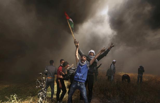 FILE PHOTO: Palestinian demonstrators shout during clashes with Israeli troops at a protest at the Israel-Gaza border east of Gaza City