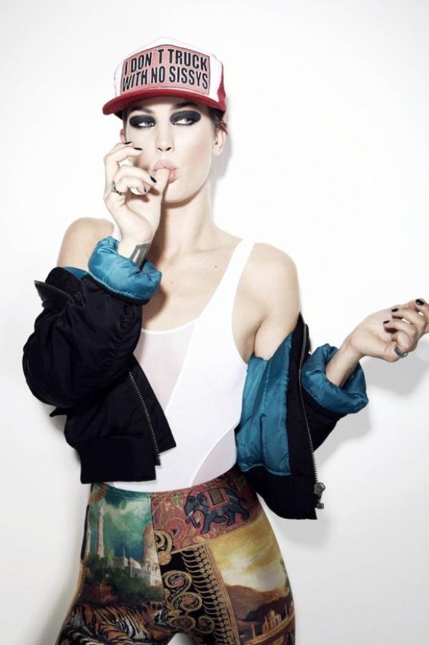 Eine Frau mit starkem Augen-Make-up und einer Kappe mit der Aufschrift „I DON'T TRUCK WITH NO SISSYS“ posiert.