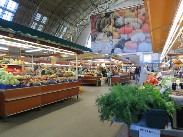 Blick in eine Halle des Rigaer Zentralmarkts mit Verkaufsständen voller Gemüse.