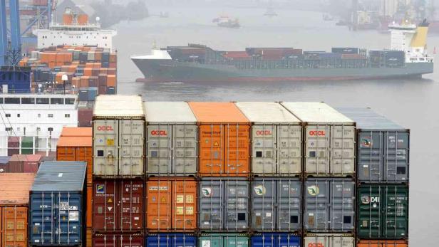 Ein Frachtschiff transportiert Container in einem Hafen.