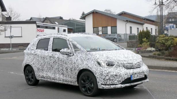 Ein mit einem Tarnmuster versehener Honda fährt auf einer Straße.