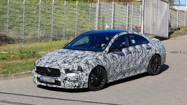 Ein Prototyp einer Mercedes-Benz A-Klasse mit Tarnmuster auf einer Straße.