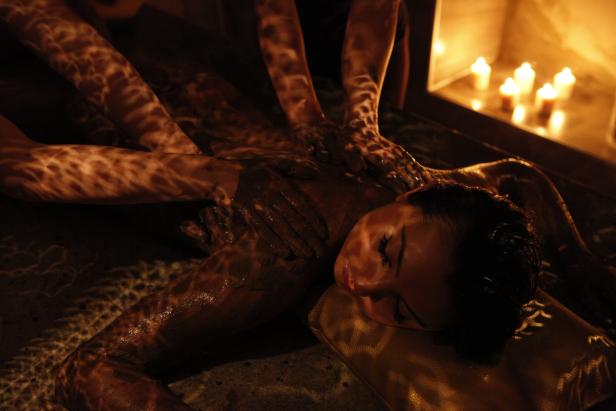 Eine Frau entspannt sich bei einer Schlammpackung und Massage in einem Spa.