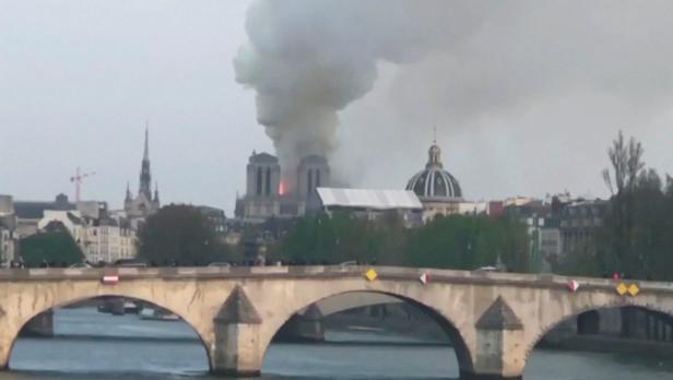 Flames and thick smoke billow from Notre Dame Cathedral in Paris