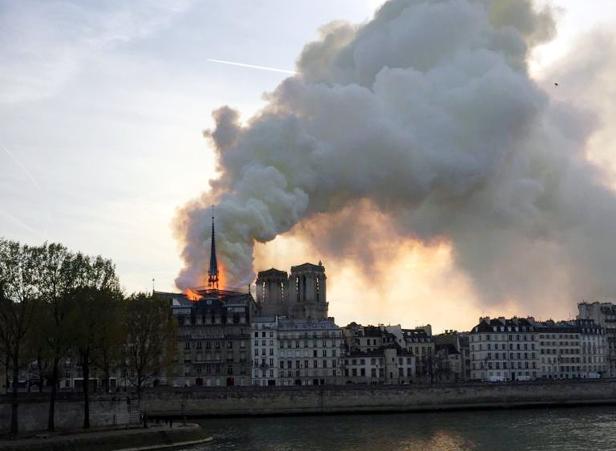 Smoke billows from the Notre Dame Cathedral after a fire broke out, in Paris