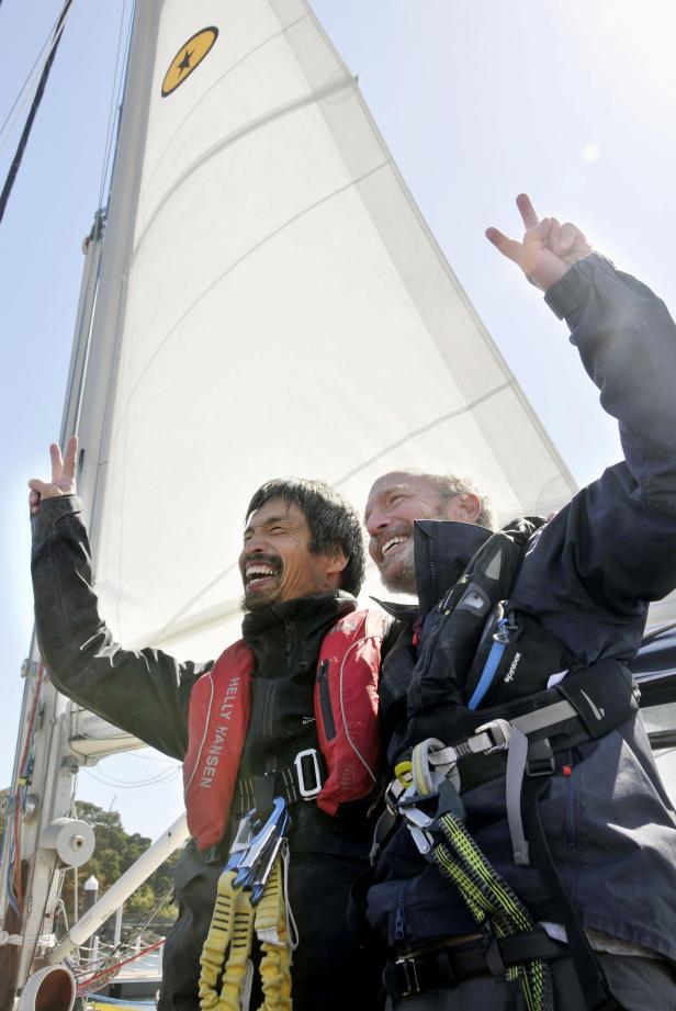 Mitsuhiro Iwamoto, a blind Japanese sailor, celebrates with his navigator Doug Smith of the U.S. after successfully completing non-stop voyage from San Diego to Fukushima Prefecture on the Pacific Ocean, upon their arrival in Iwaki