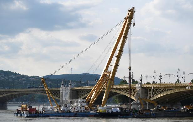 A giant floating crane stays in his final position near a bridge on the Danube River in Budapest