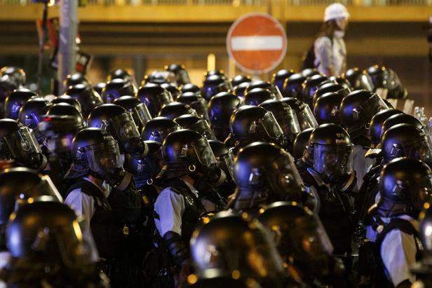 Riot police clear the streets outside the Legislative Council building, after protesters stormed the building on the anniversary of Hong Kong's handover to China in Hong Kong
