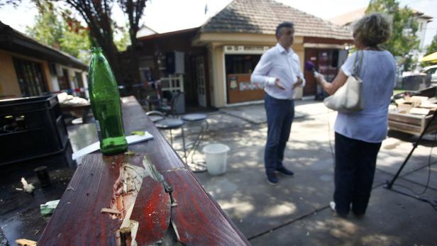 A man is interviewed in a cafe after a shooting du