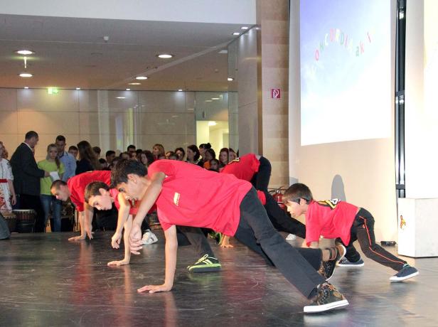 Eine Gruppe von Jungen führt eine Tanzperformance auf einer Bühne auf.