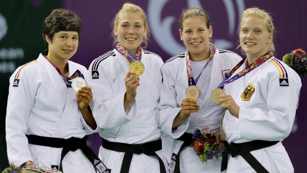 Vier Judo-Kämpferinnen mit Medaillen bei einer Siegerehrung.