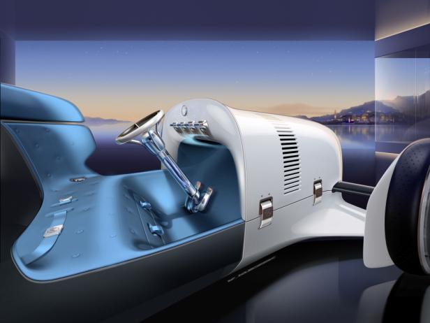 Ein futuristisches, offenes Rennwagen-Konzept mit türkisfarbenem Interieur vor einer Küstenlandschaft.