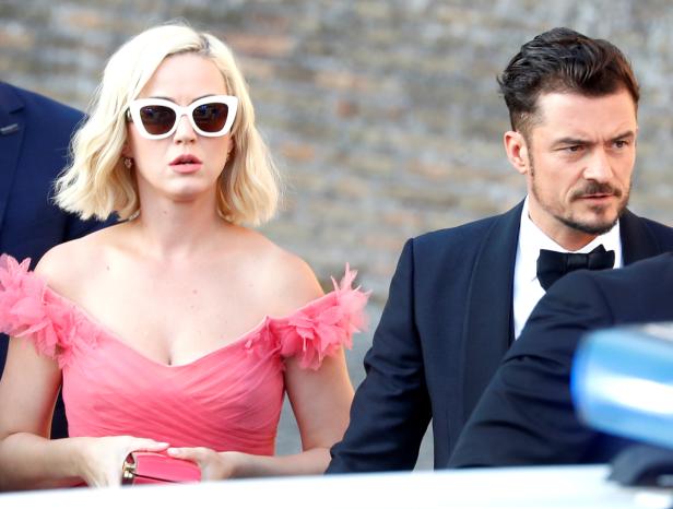 Singer Katy Perry and actor Orlando Bloom arrive to attend the wedding of fashion designer Misha Nonoo at Villa Aurelia in Rome