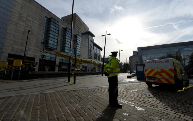 Police officer is seen outside the Arndale shopping centre after several people were stabbed in Manchester