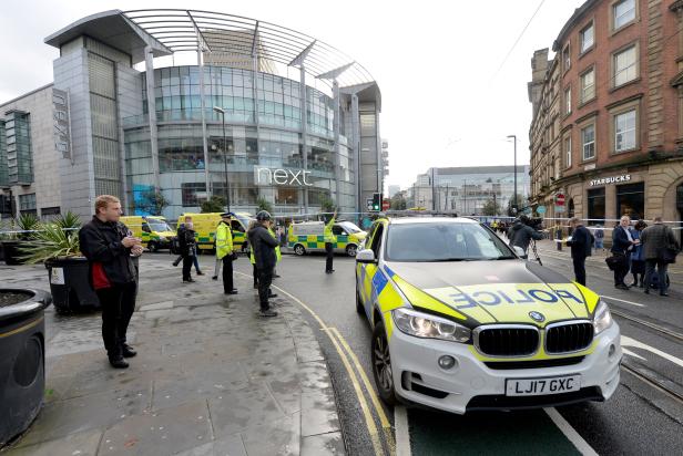 Police cars are seen outside the Arndale shopping centre after several people were stabbed in Manchester