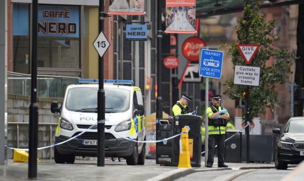 Police officers are seen outside the Arndale shopping centre after several people were stabbed in Manchester