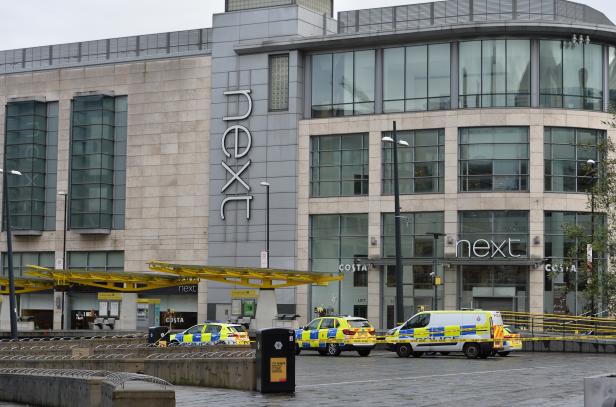 Police cars are seen outside the Arndale shopping centre after several people were stabbed in Manchester