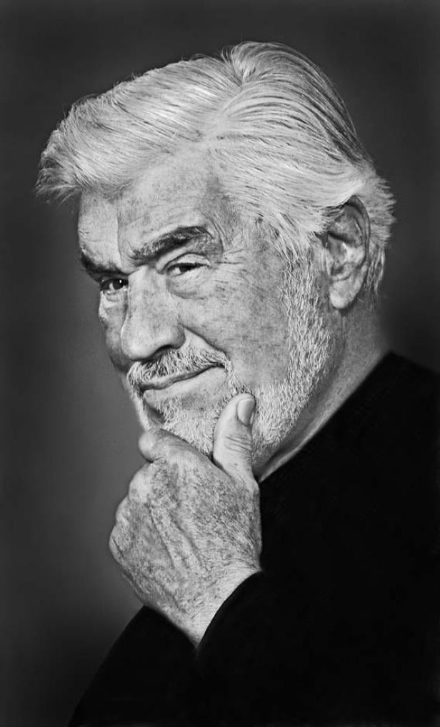 Ein Schwarzweißporträt von Sean Connery, der nachdenklich sein Kinn berührt.