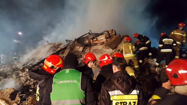 Firefighters work at the site of a building levelled by a gas explosion in Szczyrk