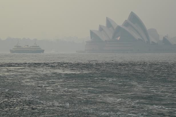 The Sydney Opera House can be seen as smoke haze from bushfires in New South Wales blankets the CBD in Sydney