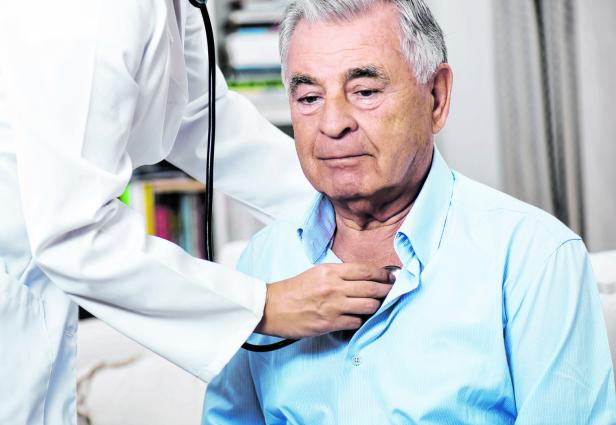 Medical Caring For Senior Man At Home
