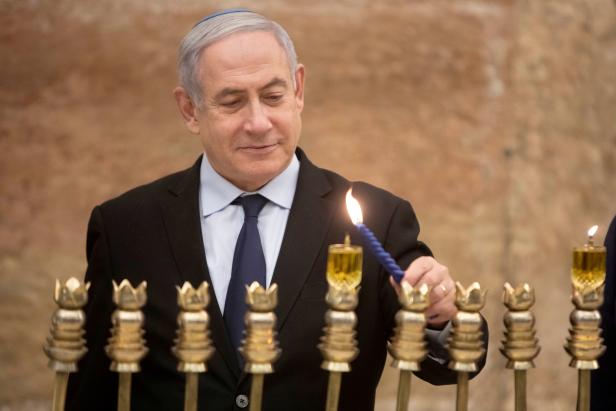 FILE PHOTO: Israel's PM Netanyahu lights first candle of Hanukkah