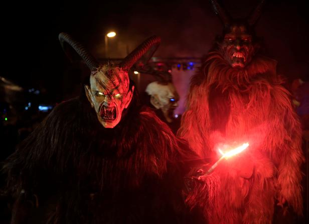 A man dressed as a demon performs during a Krampus show in Goricane