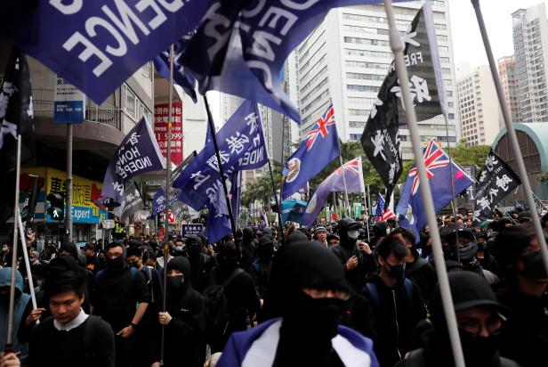 Pro-independence protesters march during an anti-government demonstration on New Year's Day, to call for better governance and democratic reforms in Hong Kong