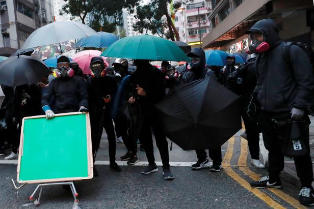 Anti-government protesters react as they standoff during a demonstration on the New Years Day to call for better governance and democratic reforms in Hong Kong