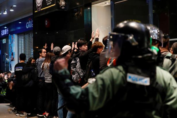 Riot police detain anti-government protesters in a large scale during a legal demonstration on the New Year's Day to call for better governance and democratic reforms in Hong Kong