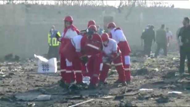 Emergency workers work near the wreckage of Ukraine International Airlines flight PS752, a Boeing 737-800 plane that crashed after taking off from Tehran's Imam Khomeini airport