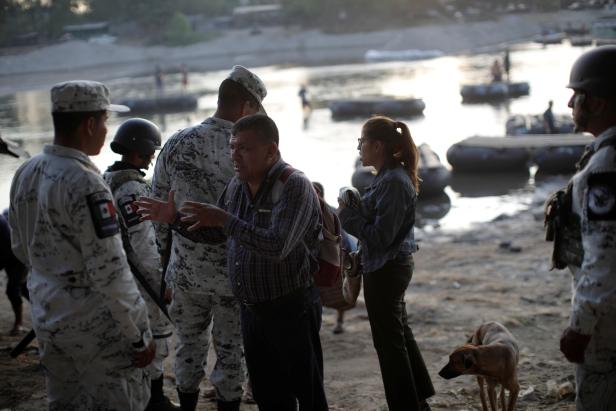 Members of Mexican security forces ask for documents people crossing the river Suchiate in Ciudad Hidalgo