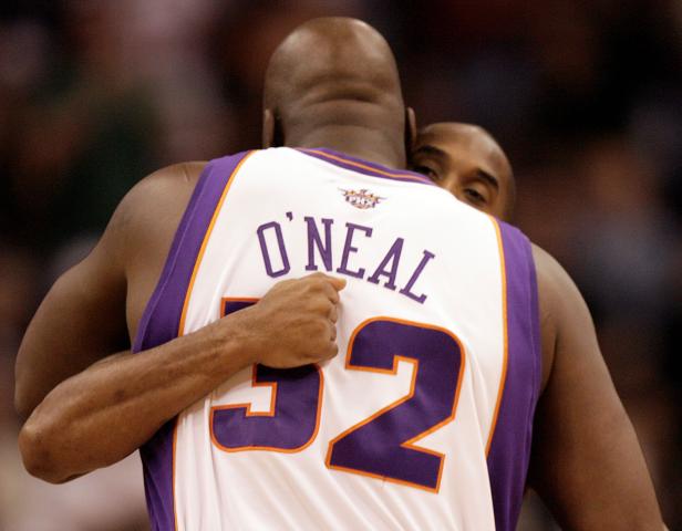 FILE PHOTO: Phoenix Suns' O'Neal hugs his former teammate Los Angeles Lakers' Bryant prior to their NBA basketball game in Phoenix