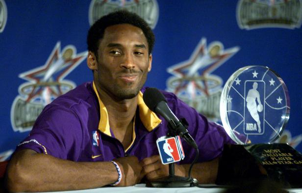 FILE PHOTO: Los Angeles Lakers Kobe Bryant, who played for the Western Conference all-stars, talks to the press as he sits next to his MVP trophy he received at the 51th NBA All-Star game in Philadelphia