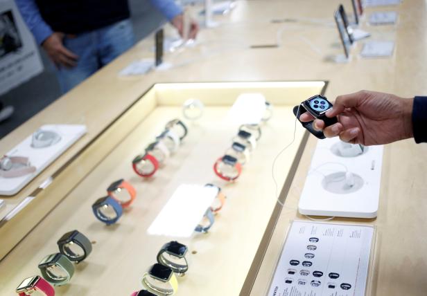 A shopper holds an Apple Watch during the shopping season, 'El Buen Fin' (The Good Weekend), at a store in Monterrey